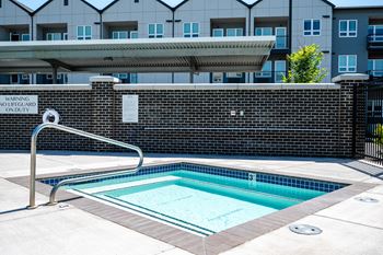a swimming pool with a building in the background
